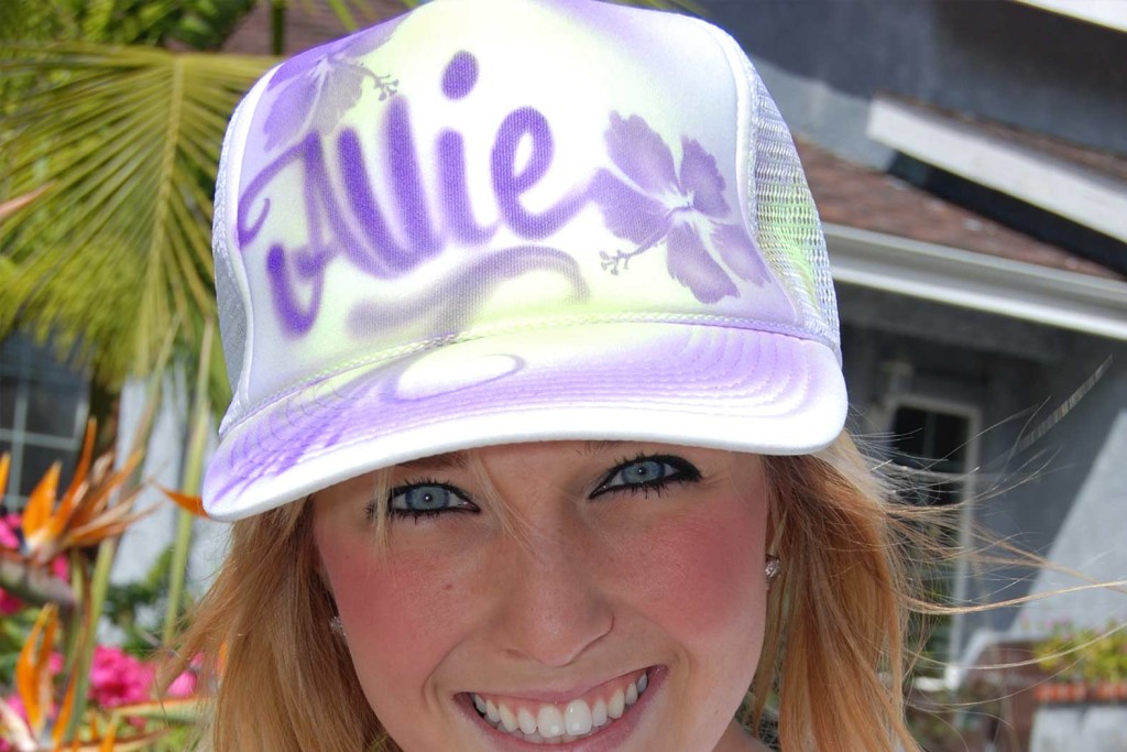 A woman wearing a purple and white hat.