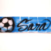 A soccer ball with the name sara written in graffiti.