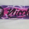A purple and pink skateboard with the name nicole written on it.